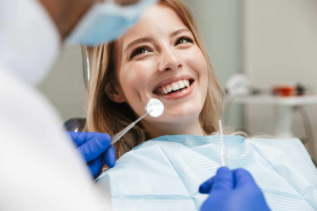 歯科医院で治療を受けて笑う女性患者