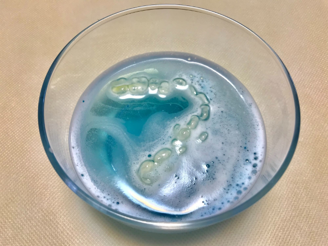マウスピースを洗浄液に浸けているイメージ