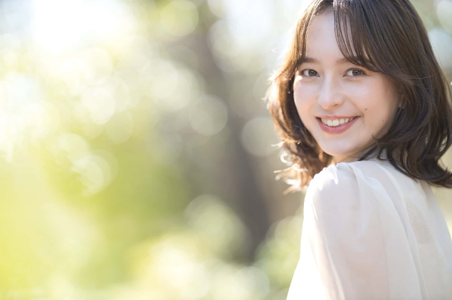 ワイヤー矯正で綺麗な歯並びになって笑顔の女性